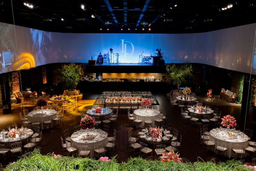Branded stage with banquet rounds and floral centrepieces