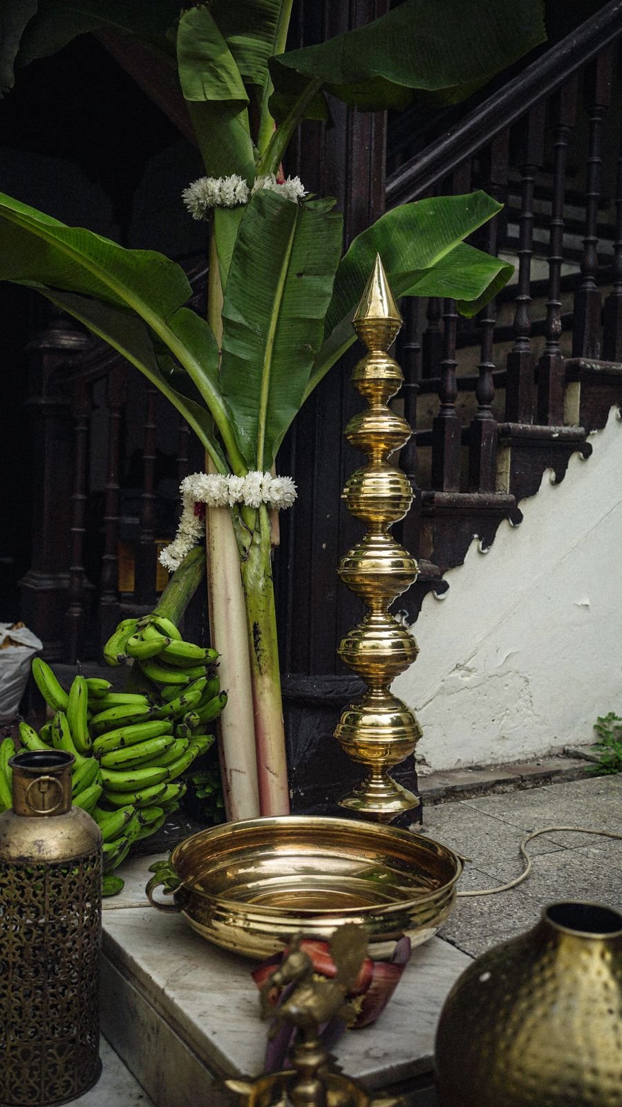 Brass urn and banana leaf styling detail for a heritage evening