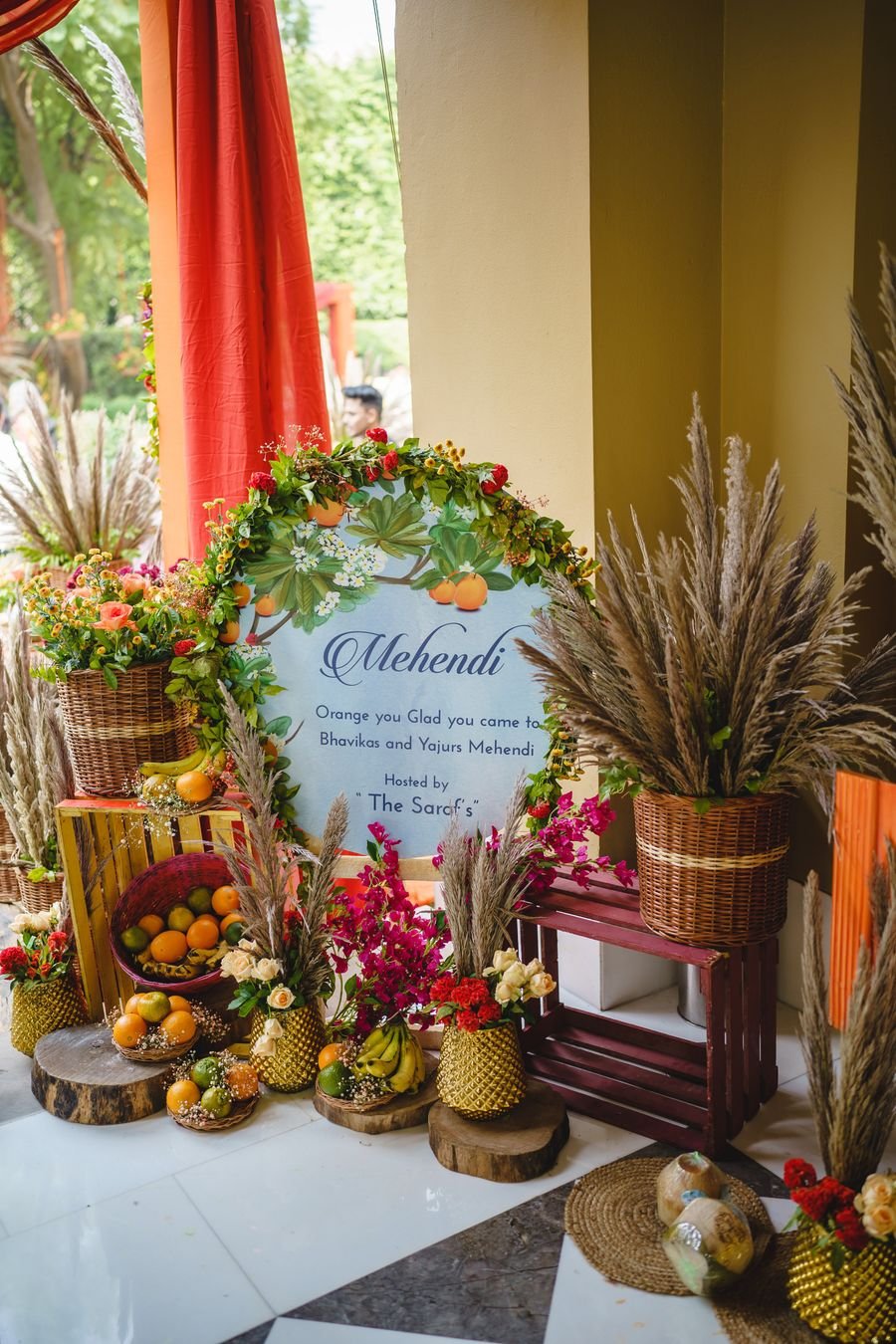 Mehendi ceremony corner styled with fruit baskets and florals